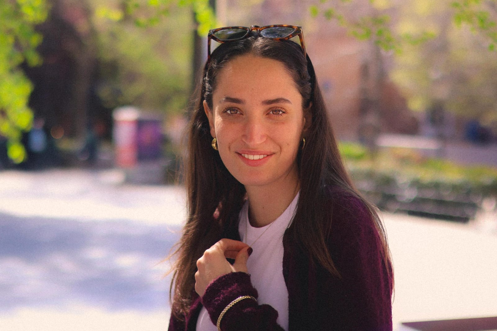 Sofia Hall smiling, sunglasses pushed up in her hair